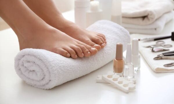 Young woman after getting professional pedicure in beauty salon, closeup